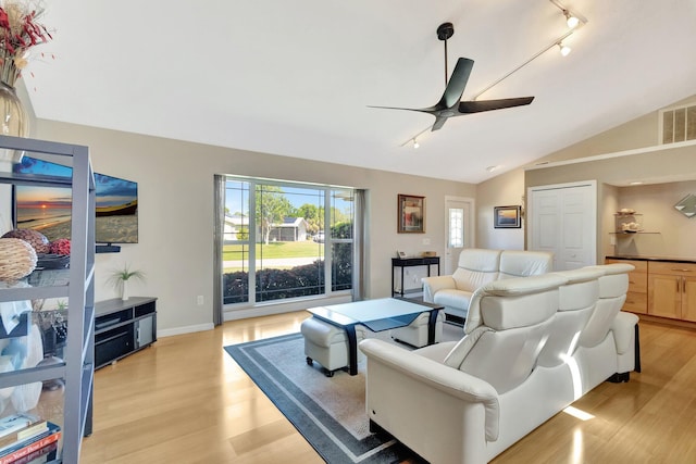 1434 SE Kirke Ln, Port Saint Lucie, FL 34983 - living room with ceiling fan, light wood-style floors, vaulted ceiling, and track lighting