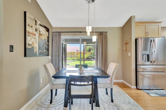 1434 SE Kirke Ln, Port Saint Lucie, FL 34983 - dining space featuring baseboards and light wood-style flooring