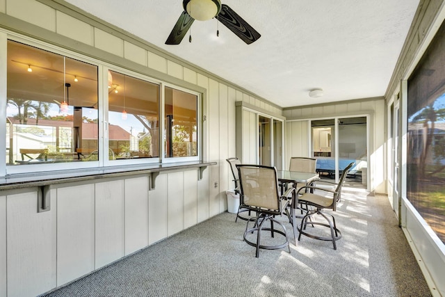 1434 SE Kirke Ln, Port Saint Lucie, FL 34983 - sunroom with carpet flooring, ornamental molding, ceiling fan, outdoor dining area, and a textured ceiling