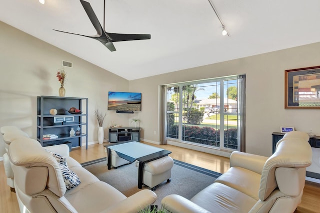 1434 SE Kirke Ln, Port Saint Lucie, FL 34983 - living area featuring wood finished floors, a ceiling fan, vaulted ceiling, and track lighting