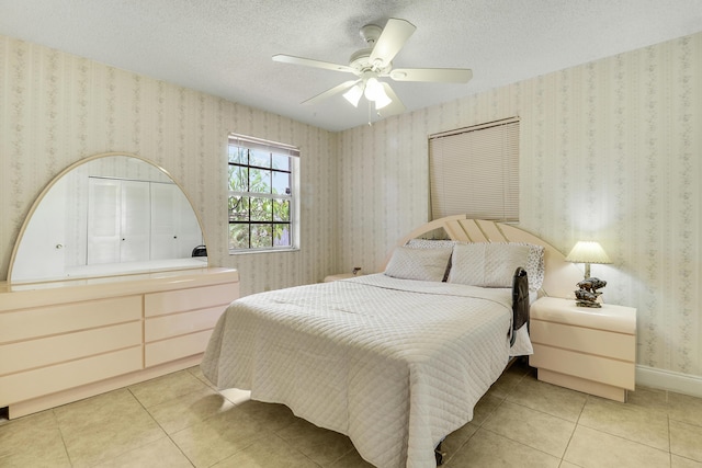 968 Sumter Rd W, West Palm Beach, FL 33415 - bedroom with light tile patterned floors, a ceiling fan, wallpapered walls, and a textured ceiling