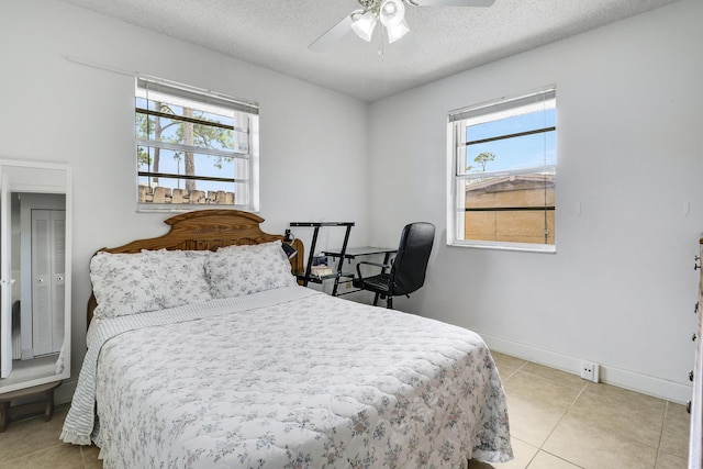 968 Sumter Rd W, West Palm Beach, FL 33415 - bedroom featuring light tile patterned floors, multiple windows, a ceiling fan, and a textured ceiling