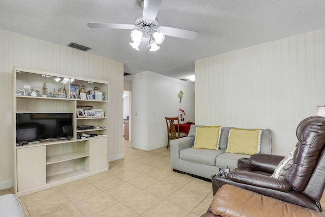 968 Sumter Rd W, West Palm Beach, FL 33415 - living room with wallpapered walls, a ceiling fan, a textured ceiling, and light tile patterned floors