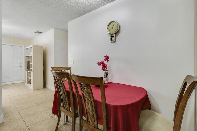 968 Sumter Rd W, West Palm Beach, FL 33415 - tiled dining room featuring a textured ceiling and baseboards