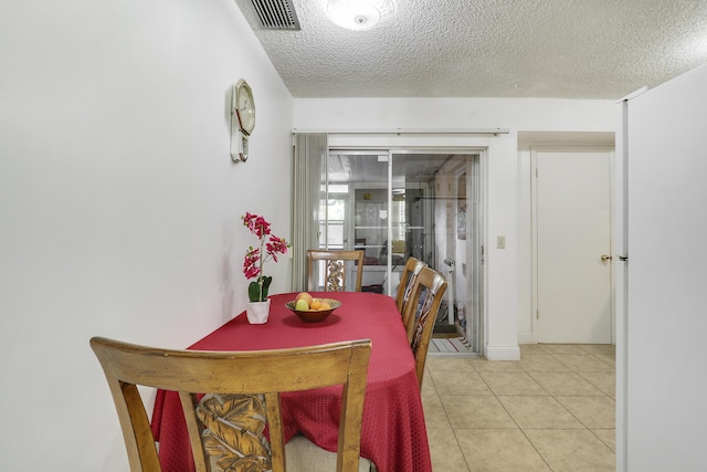 968 Sumter Rd W, West Palm Beach, FL 33415 - dining space with light tile patterned floors and a textured ceiling