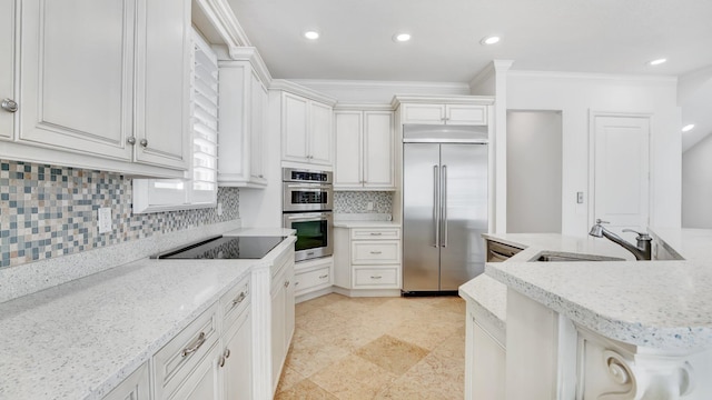4917 Watersong Way, Fort Pierce, FL 34949 - kitchen featuring appliances with stainless steel finishes, ornamental molding, decorative backsplash, recessed lighting, and light stone countertops