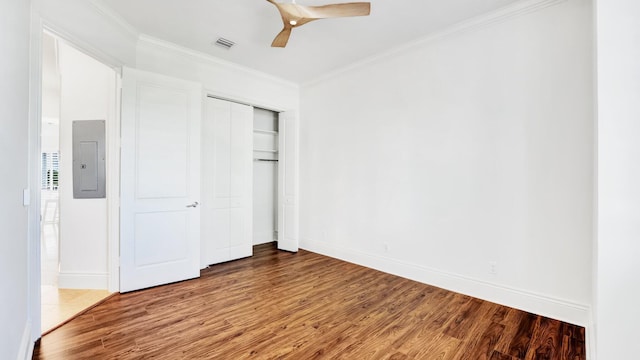 4917 Watersong Way, Fort Pierce, FL 34949 - unfurnished bedroom featuring electric panel, wood finished floors, ornamental molding, a closet, and ceiling fan