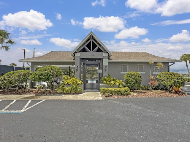 5900 S Golden Beauty Ln Unit 5900, Tamarac, FL 33321 - view of front of property featuring a fenced front yard, stucco siding, uncovered parking, and a gate