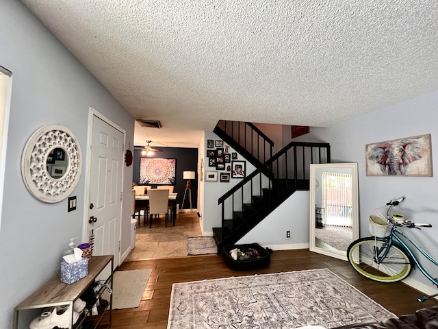 1535 Masters Cir Unit 148, Delray Beach, FL 33445 - entrance foyer featuring a textured ceiling, stairway, and hardwood / wood-style floors