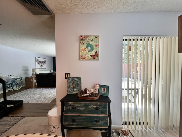 1535 Masters Cir Unit 148, Delray Beach, FL 33445 - corridor with a textured ceiling, plenty of natural light, and tile patterned floors