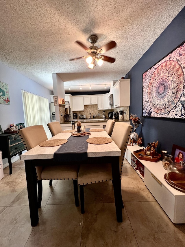 1535 Masters Cir Unit 148, Delray Beach, FL 33445 - dining area with a ceiling fan and a textured ceiling