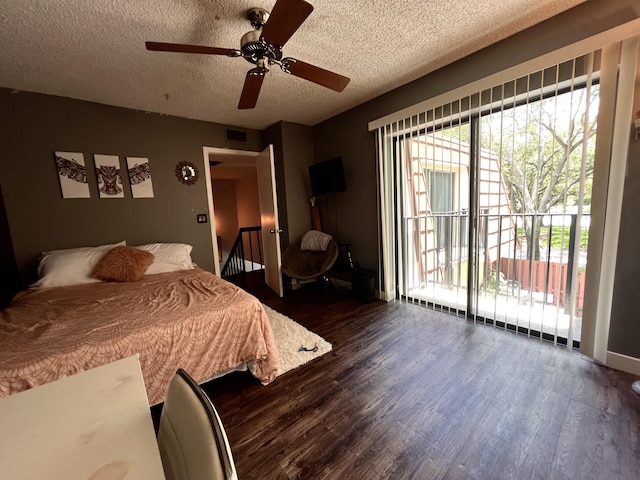 1535 Masters Cir Unit 148, Delray Beach, FL 33445 - bedroom with dark wood-style flooring, a textured ceiling, a ceiling fan, and access to exterior