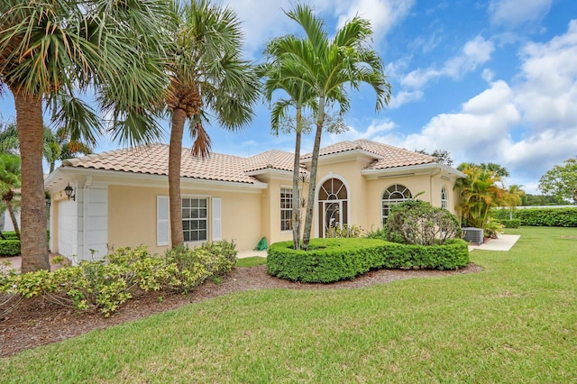 8851 Oldham Way, Palm Beach Gardens, FL 33412 - mediterranean / spanish home featuring a front yard, stucco siding, a tile roof, and a garage