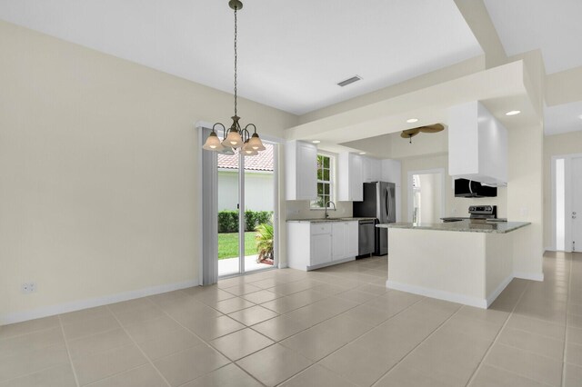 8851 Oldham Way, Palm Beach Gardens, FL 33412 - kitchen featuring stainless steel appliances, a chandelier, white cabinets, and light tile patterned flooring