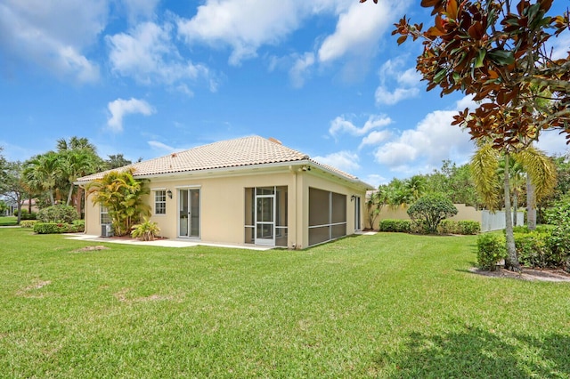 8851 Oldham Way, Palm Beach Gardens, FL 33412 - back of house with a tile roof, stucco siding, a sunroom, and a garage