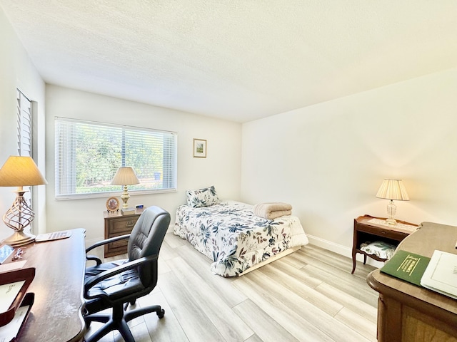 312 Knotty Pine Cir Unit C-1, Greenacres, FL 33463 - bedroom with wood finished floors, a desk, and a textured ceiling