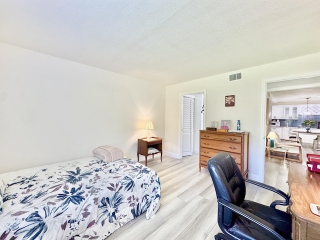 312 Knotty Pine Cir Unit C-1, Greenacres, FL 33463 - bedroom with light wood finished floors and a chandelier