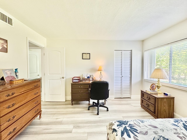312 Knotty Pine Cir Unit C-1, Greenacres, FL 33463 - bedroom featuring light wood finished floors, an office area, and a textured ceiling