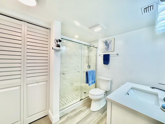312 Knotty Pine Cir Unit C-1, Greenacres, FL 33463 - full bathroom featuring a shower stall, wood finished floors, vanity, a closet, and recessed lighting