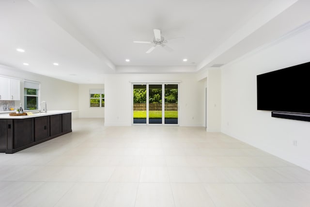 2571 SW Berry Park Cir, Palm City, FL 34990 - unfurnished living room with a ceiling fan, healthy amount of natural light, recessed lighting, and a raised ceiling