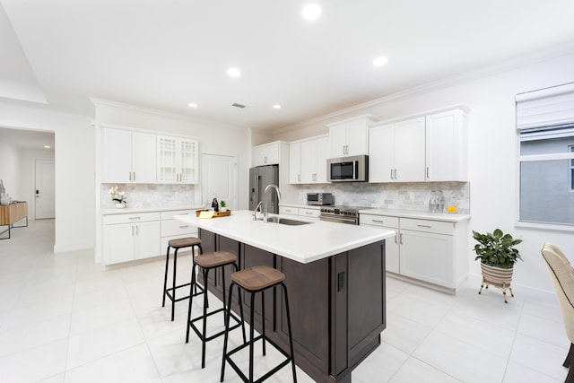 2571 SW Berry Park Cir, Palm City, FL 34990 - kitchen with appliances with stainless steel finishes, a kitchen breakfast bar, backsplash, a center island with sink, and recessed lighting