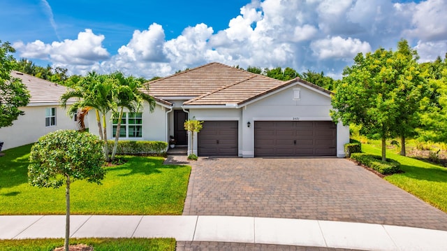 2571 SW Berry Park Cir, Palm City, FL 34990 - single story home with an attached garage, a front yard, a tile roof, and stucco siding