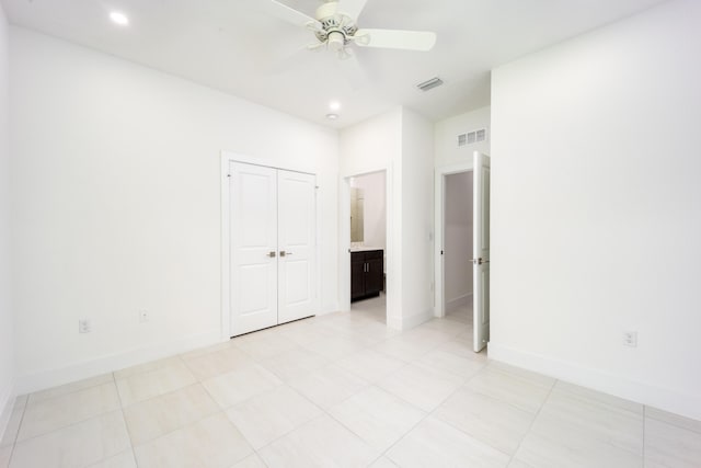 2571 SW Berry Park Cir, Palm City, FL 34990 - unfurnished bedroom featuring a closet, recessed lighting, a ceiling fan, light tile patterned floors, and connected bathroom