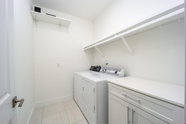 2571 SW Berry Park Cir, Palm City, FL 34990 - laundry area featuring washing machine and clothes dryer, light tile patterned floors, and cabinet space
