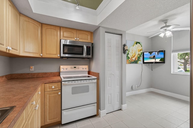 16 Willowbrook Ln Unit 102, Delray Beach, FL 33446 - kitchen featuring stainless steel microwave, white range with electric stovetop, light tile patterned floors, crown molding, and a ceiling fan