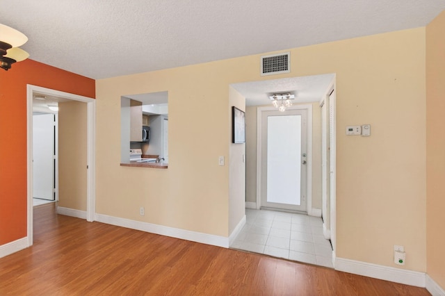 16 Willowbrook Ln Unit 102, Delray Beach, FL 33446 - entryway with wood finished floors and a textured ceiling