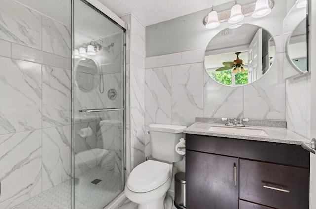 16 Willowbrook Ln Unit 102, Delray Beach, FL 33446 - bathroom featuring tile walls, vanity, a marble finish shower, ceiling fan, and a textured ceiling