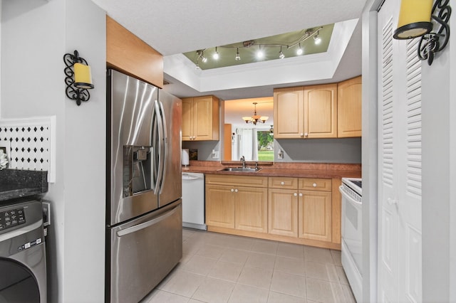16 Willowbrook Ln Unit 102, Delray Beach, FL 33446 - kitchen featuring white appliances, washer / dryer, a chandelier, light tile patterned floors, and light brown cabinetry