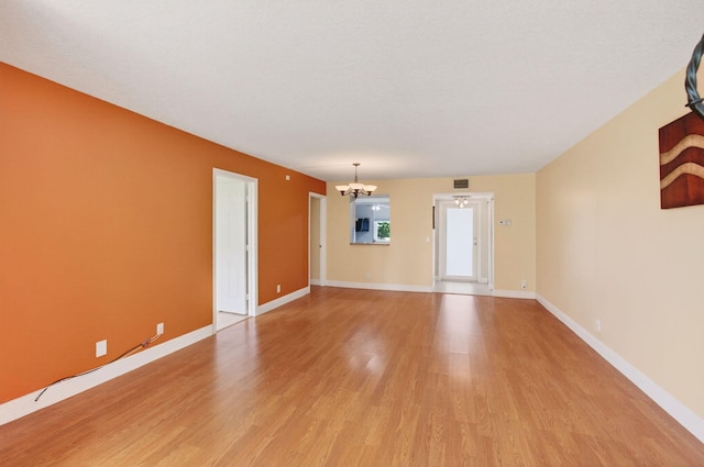 16 Willowbrook Ln Unit 102, Delray Beach, FL 33446 - spare room with a chandelier and light wood-style floors