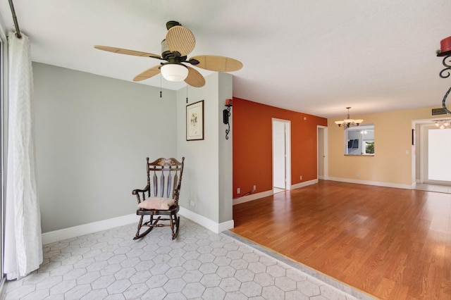 16 Willowbrook Ln Unit 102, Delray Beach, FL 33446 - sitting room featuring a ceiling fan, a chandelier, and wood finished floors