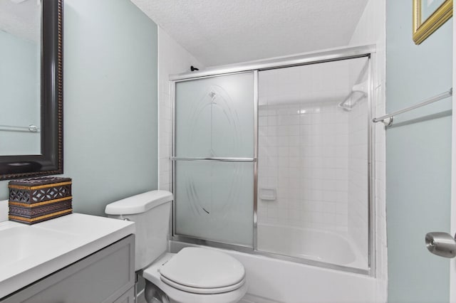 16 Willowbrook Ln Unit 102, Delray Beach, FL 33446 - bathroom with a textured ceiling, vanity, and enclosed tub / shower combo