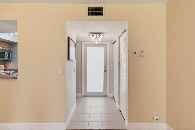 16 Willowbrook Ln Unit 102, Delray Beach, FL 33446 - entryway featuring baseboards and light tile patterned flooring