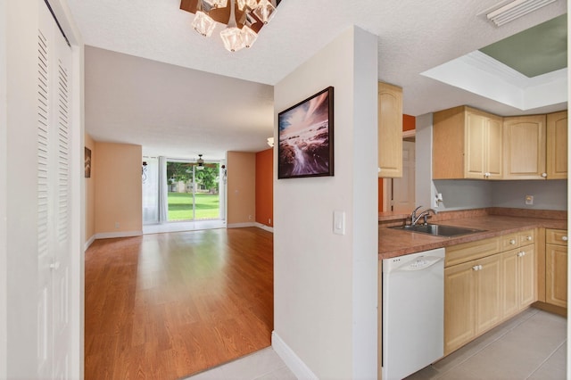16 Willowbrook Ln Unit 102, Delray Beach, FL 33446 - kitchen featuring white dishwasher, light brown cabinetry, open floor plan, a chandelier, and light wood-style floors
