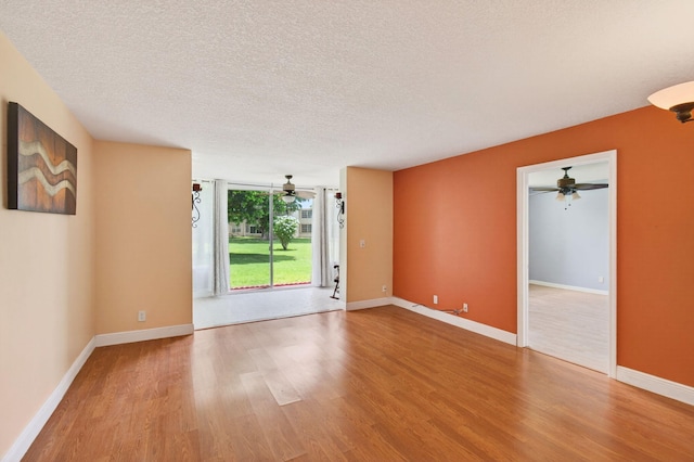 16 Willowbrook Ln Unit 102, Delray Beach, FL 33446 - empty room with ceiling fan, wood finished floors, and a textured ceiling
