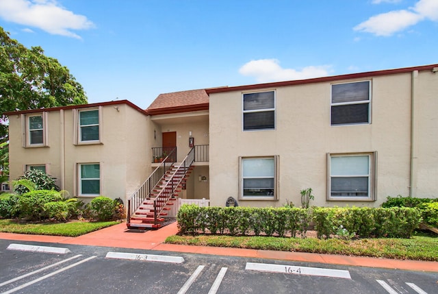 16 Willowbrook Ln Unit 102, Delray Beach, FL 33446 - view of property with uncovered parking and stairs