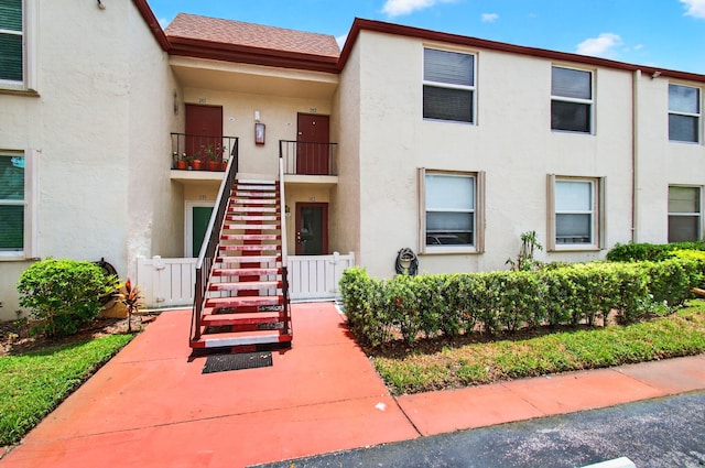 16 Willowbrook Ln Unit 102, Delray Beach, FL 33446 - view of building exterior featuring stairway