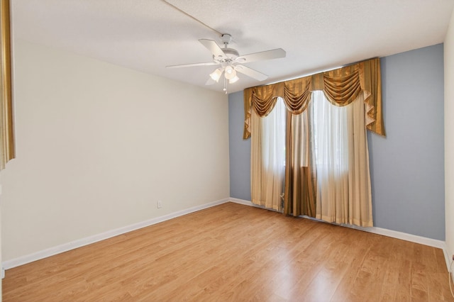 16 Willowbrook Ln Unit 102, Delray Beach, FL 33446 - empty room with wood finished floors, ceiling fan, and a textured ceiling