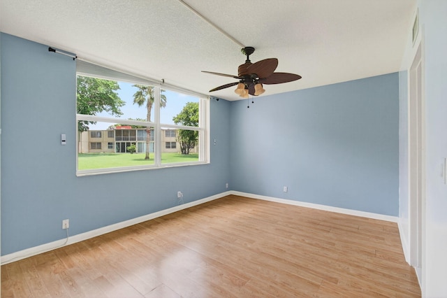16 Willowbrook Ln Unit 102, Delray Beach, FL 33446 - empty room featuring a ceiling fan, light wood finished floors, and a textured ceiling