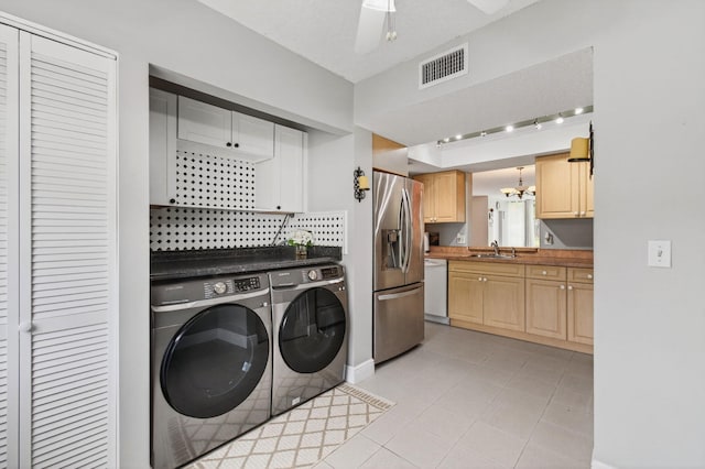 16 Willowbrook Ln Unit 102, Delray Beach, FL 33446 - washroom with washing machine and dryer, track lighting, a chandelier, ceiling fan, and light tile patterned floors