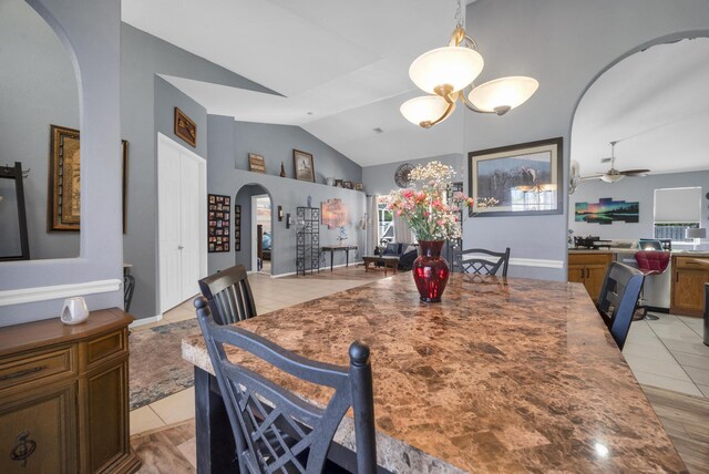 3982 SW Kabane St, Port Saint Lucie, FL 34953 - dining space with arched walkways, lofted ceiling, a ceiling fan, and light tile patterned flooring