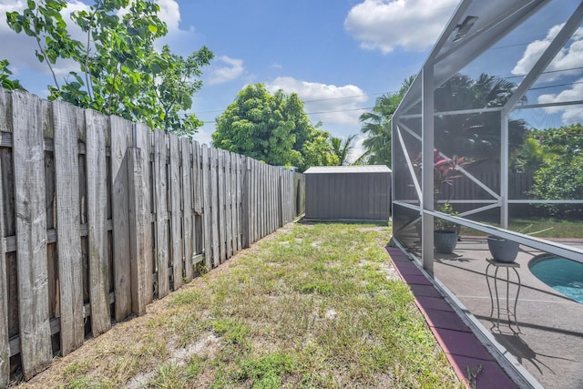 3982 SW Kabane St, Port Saint Lucie, FL 34953 - fenced backyard featuring a storage shed, a lanai, and a patio area