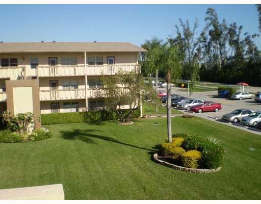 495 Fanshaw L Unit 495, Boca Raton, FL 33434 - surrounding community with uncovered parking and a yard