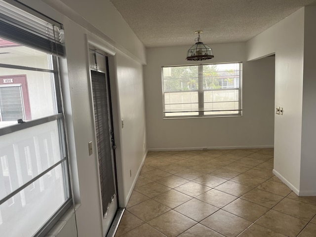 495 Fanshaw L Unit 495, Boca Raton, FL 33434 - empty room featuring light tile patterned floors and a textured ceiling