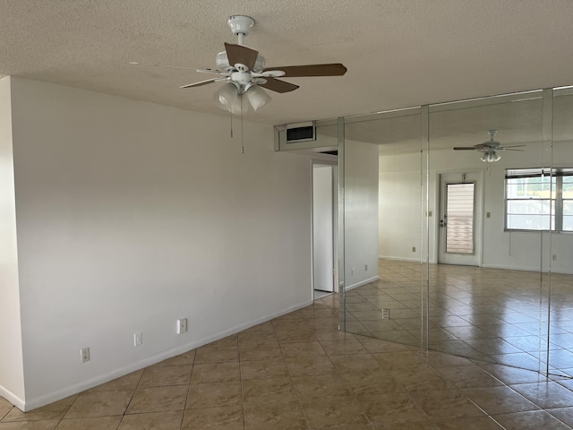 495 Fanshaw L Unit 495, Boca Raton, FL 33434 - tiled empty room with a ceiling fan and a textured ceiling