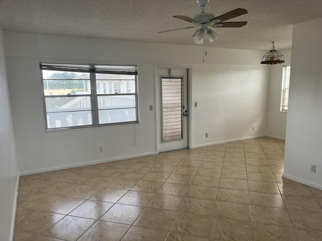 495 Fanshaw L Unit 495, Boca Raton, FL 33434 - tiled empty room featuring a textured ceiling and ceiling fan