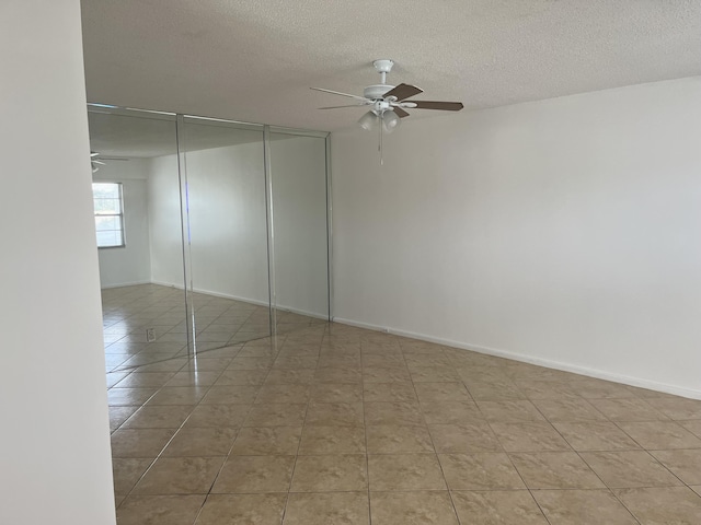 495 Fanshaw L Unit 495, Boca Raton, FL 33434 - tiled empty room with a ceiling fan and a textured ceiling
